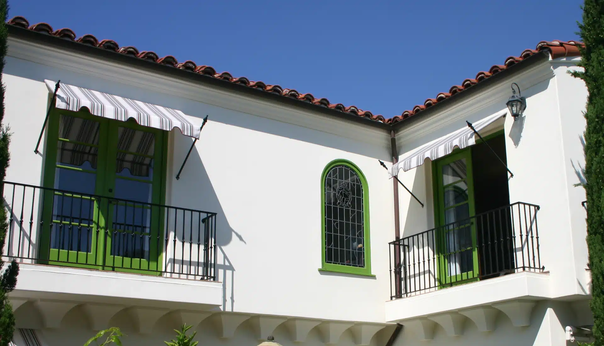 close up of a houses windows with spear decorative awnings installed santa ana ca