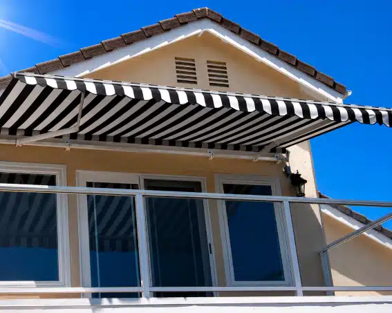 Uni-Lux retractable awning arms shown extending to demonstrate how retractable awnings create shaded patio space