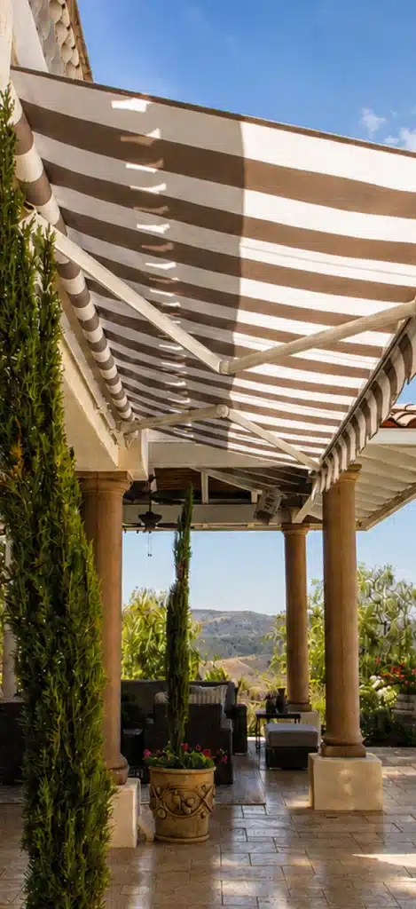 Vertical close-up of the Uni-Lux awning's arm joint and fabric roller tube construction